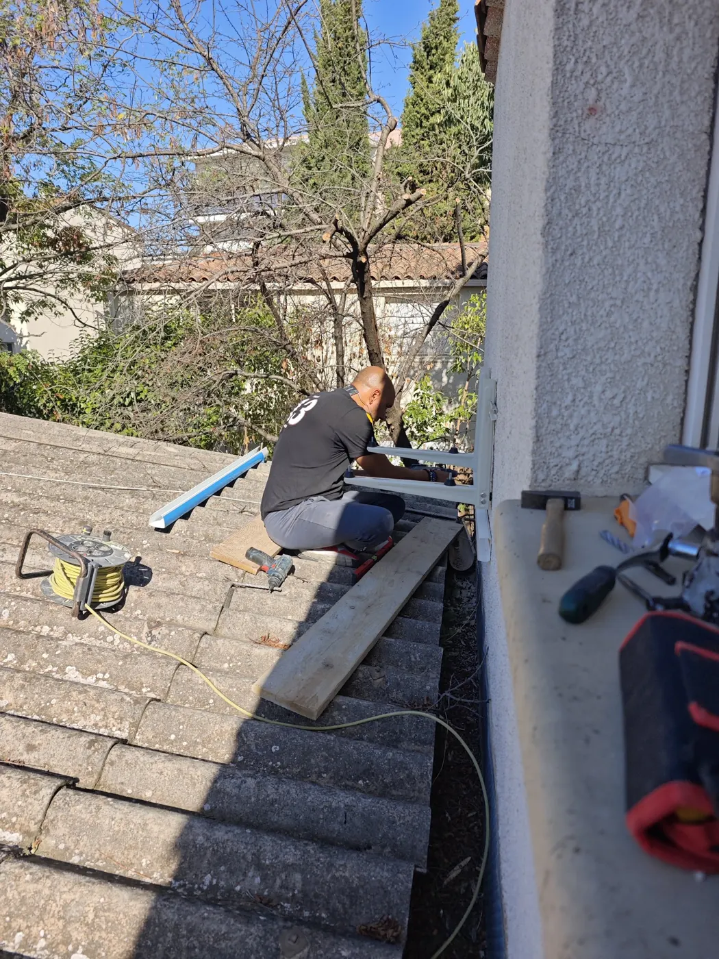 Frigoriste Solar&Clim réalisant les liaisons d’une climatisation depuis une toiture en tuiles